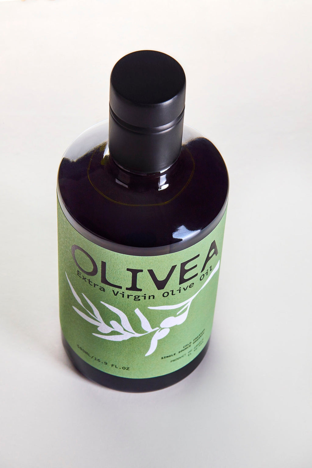 Bottle of Olivea extra virgin olive oil on a white background